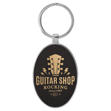 Load image into Gallery viewer, Black/Gold 3" x 1 3/4" Laserable Leatherette/Metal Oval Keychain