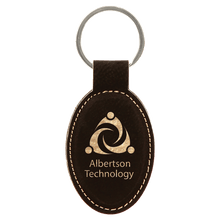 Load image into Gallery viewer, Black/Gold 3" x 1 3/4" Laserable Leatherette Oval Keychain
